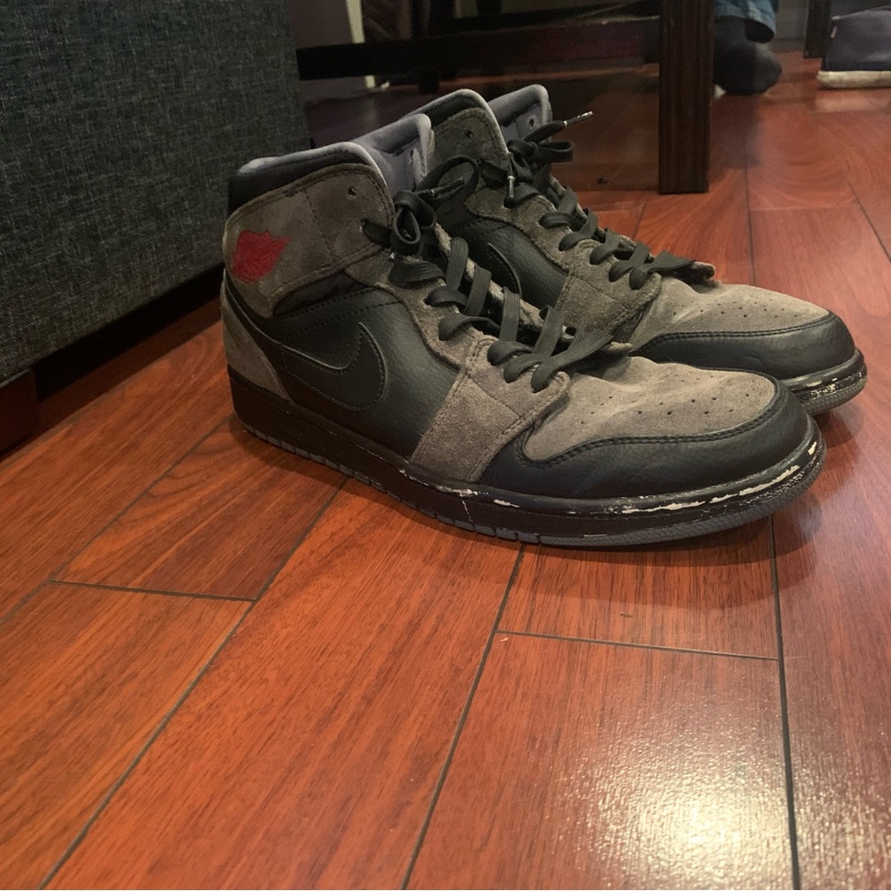 Black, grey and red Jordan 1 mids.